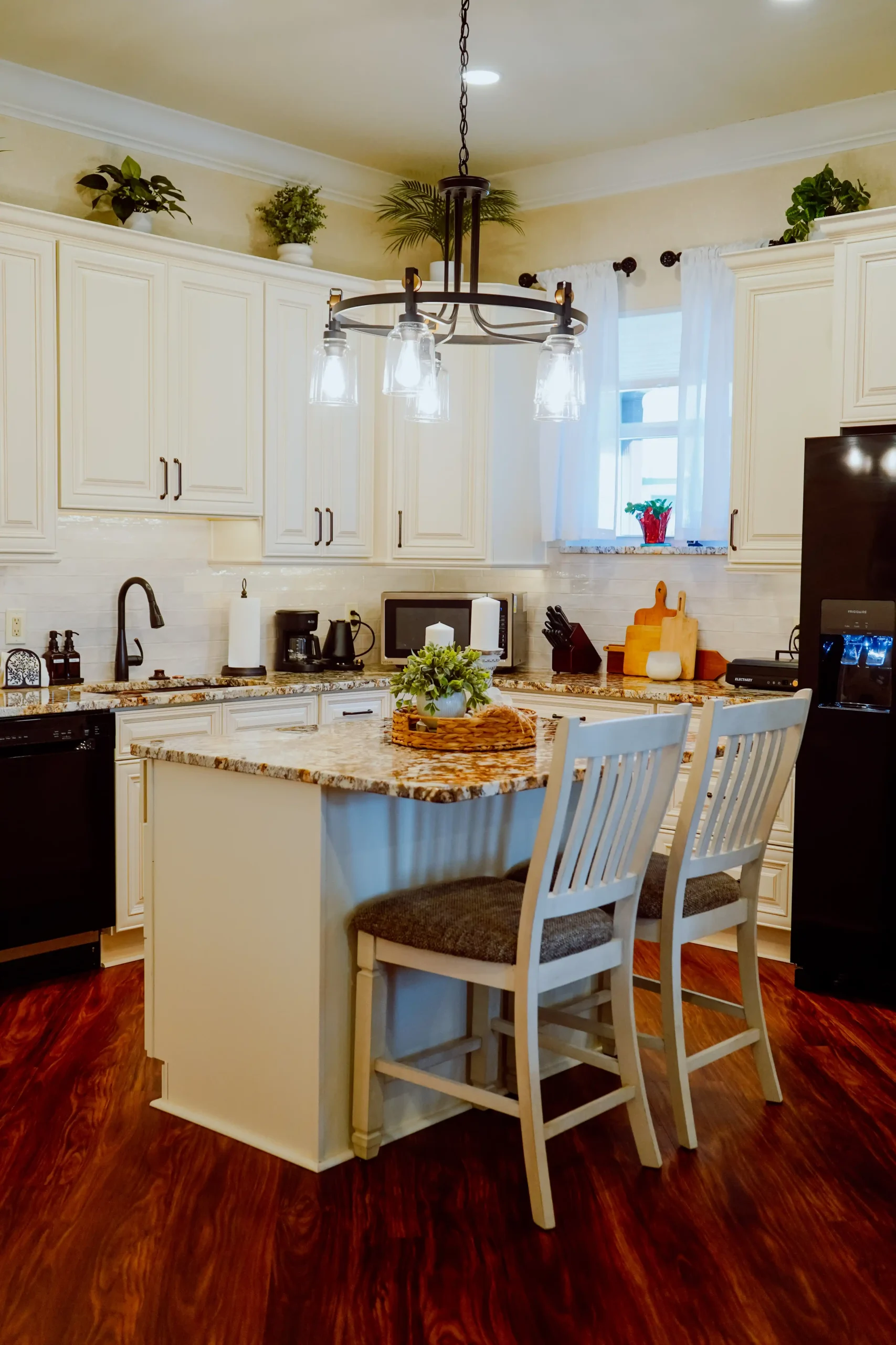 Kitchen with white cabinets and granite island