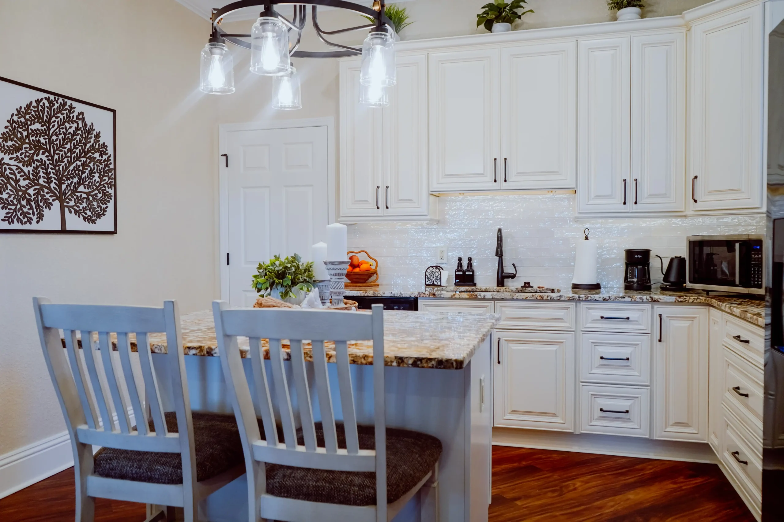 Suite kitchen with island and stainless appliances